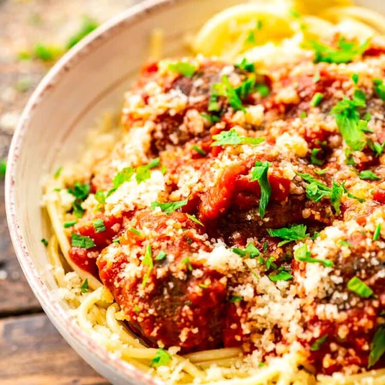 Spaghetti and meatballs in a cream bowl