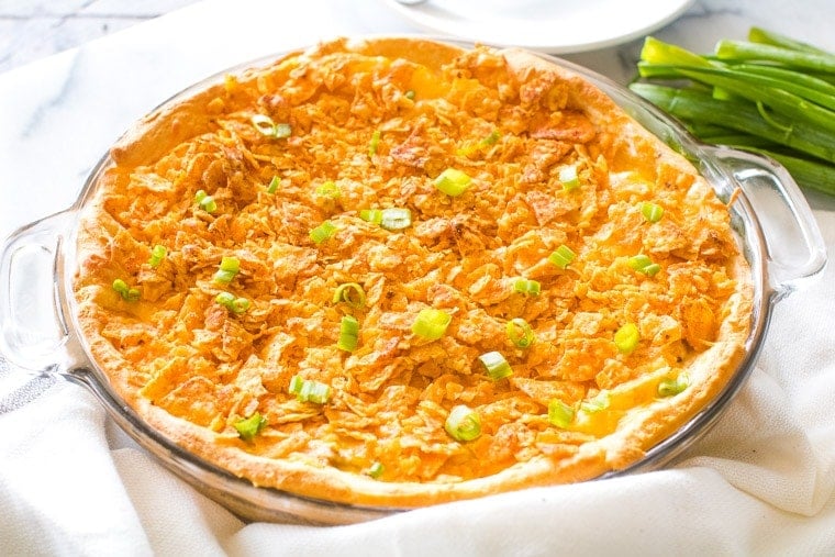 Taco Pie in glass pie plate sitting on white napkin