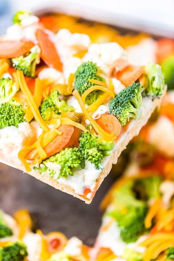 Slice of Veggie Pizza being removed from the pan.