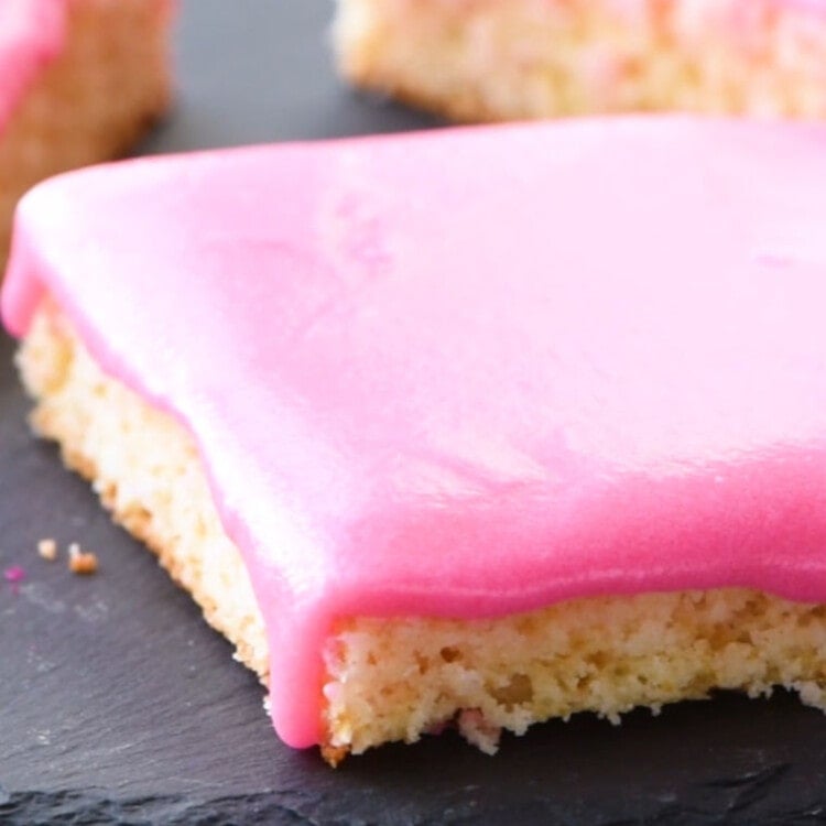 Sugar Cookie Bars cut into pieces on a slate tray