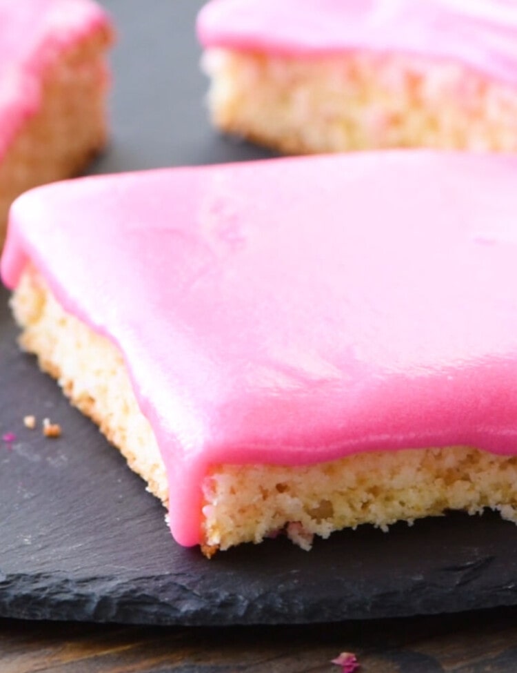 Sugar Cookie Bars cut into pieces on a slate tray