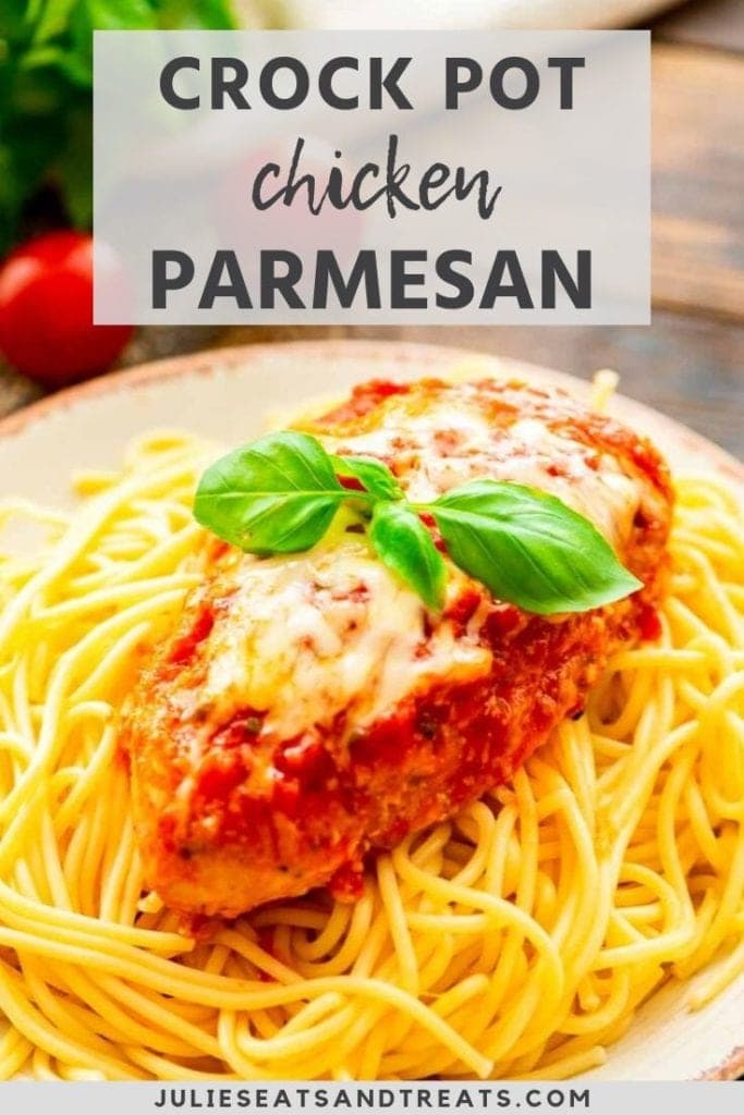 Prepared chicken parmesan on top of a plate of spaghetti noodles