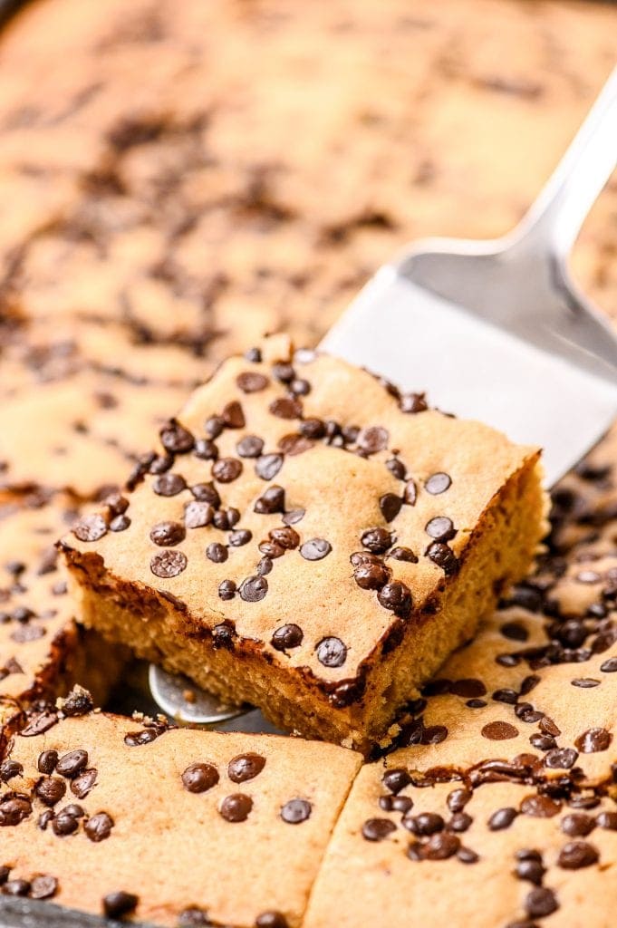 Spatula with a cut brownie on it holding it above pan