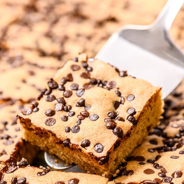 Spatula with a cut brownie on it holding it above pan