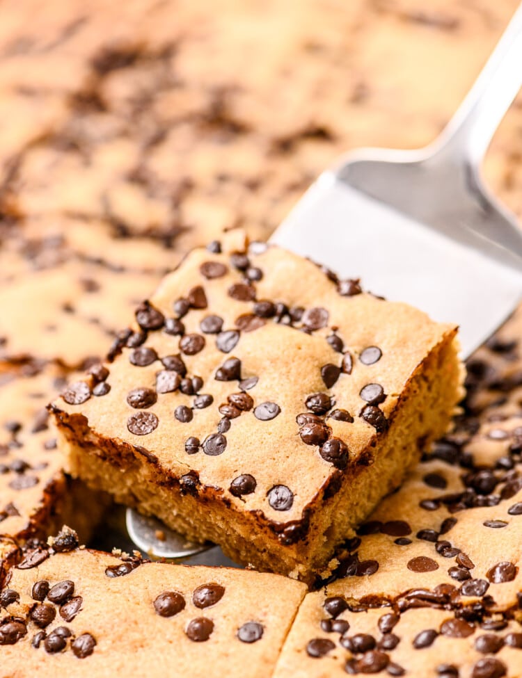 Spatula with a cut brownie on it holding it above pan