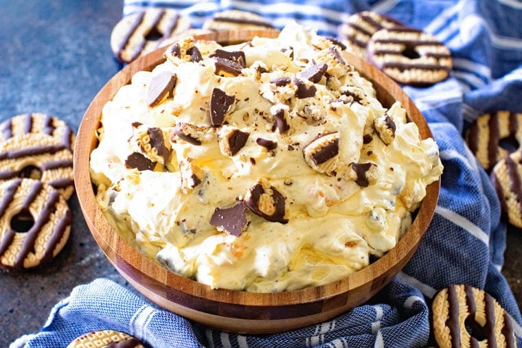 Wooden bowl with cookie salad in it topped with crushed Fudge Striped Cookies