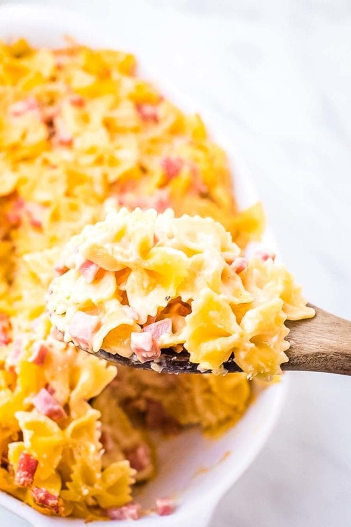 Cheesy Ham Bow Tie Pasta on wooden spoon