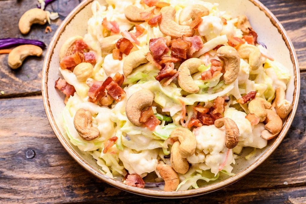 Closeup showing coleslaw salad in bowl on brown background