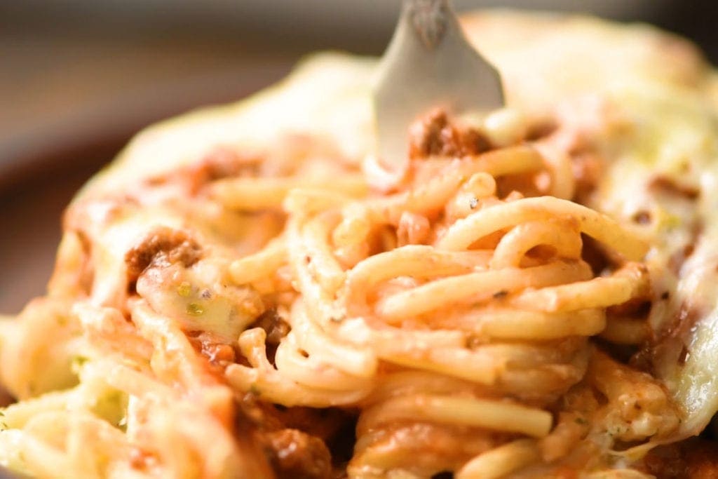 Baked Spaghetti pasta being twirled around a fork.