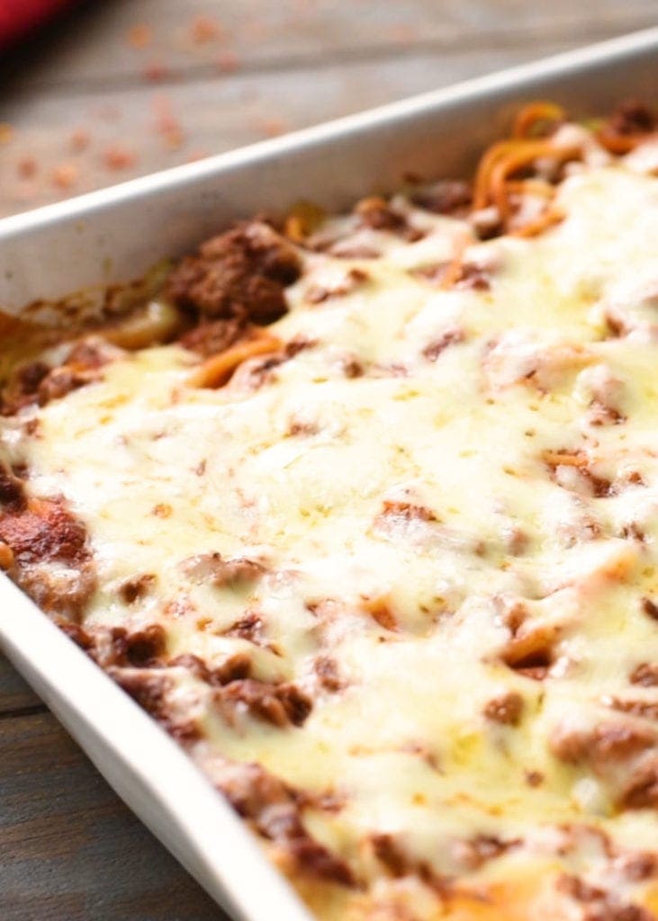 Baked Spaghetti Casserole topped with melted mozzarella in pan