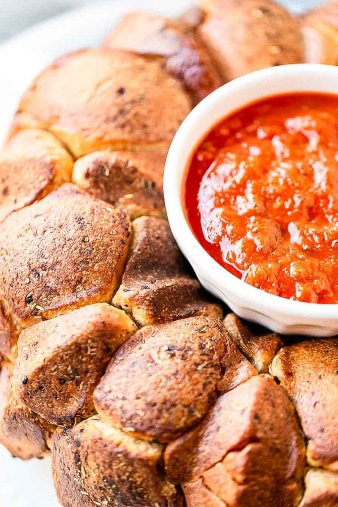 Monkey Bread with a white bowl in the center of marinara