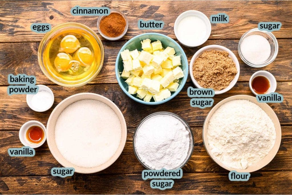 Overhead image showing all the ingredients to make Snickerdoodle Bars in cups eggs, butter cinnamon, flour, sugar, vanilla and more