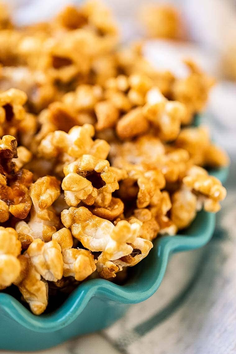 Teal Bowl with scalloped edge holding caramel corn.