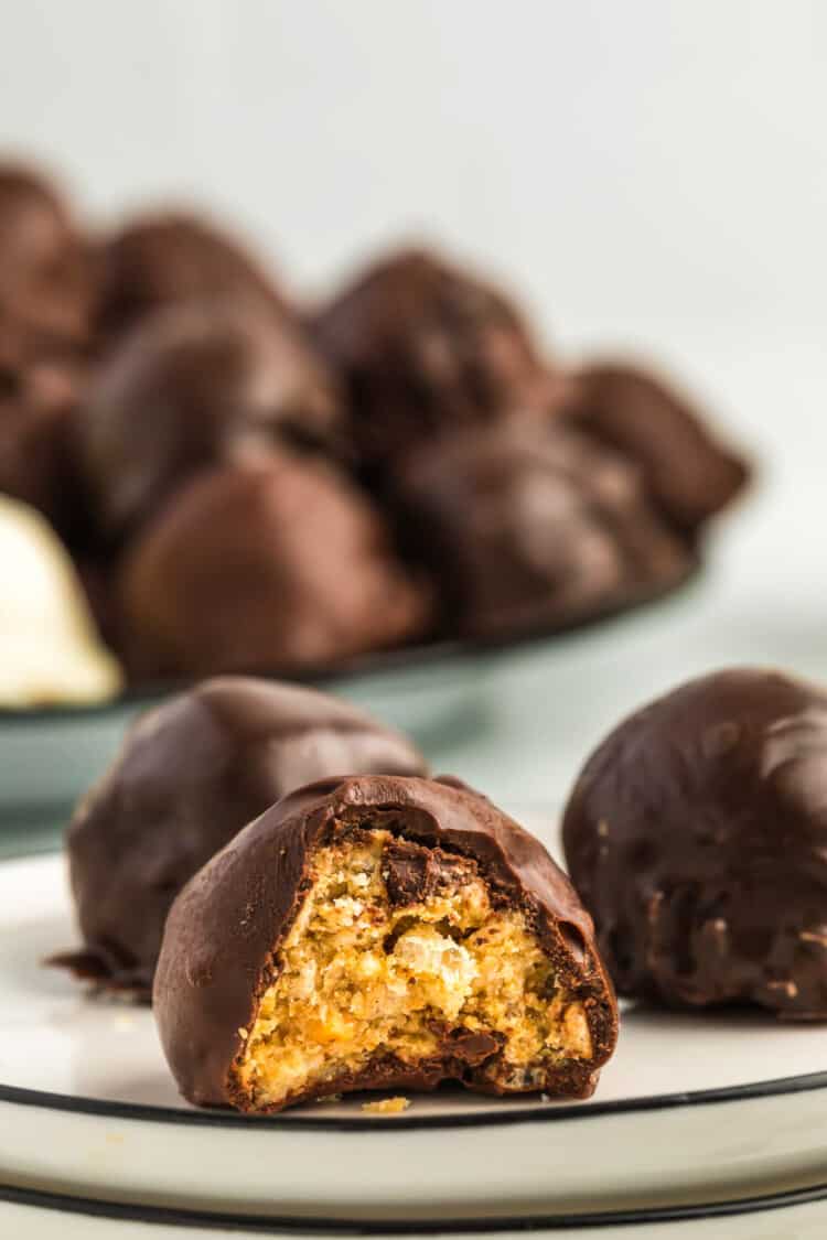 Peanut Butter Balls with Rice Krispies with a bite gone on plate