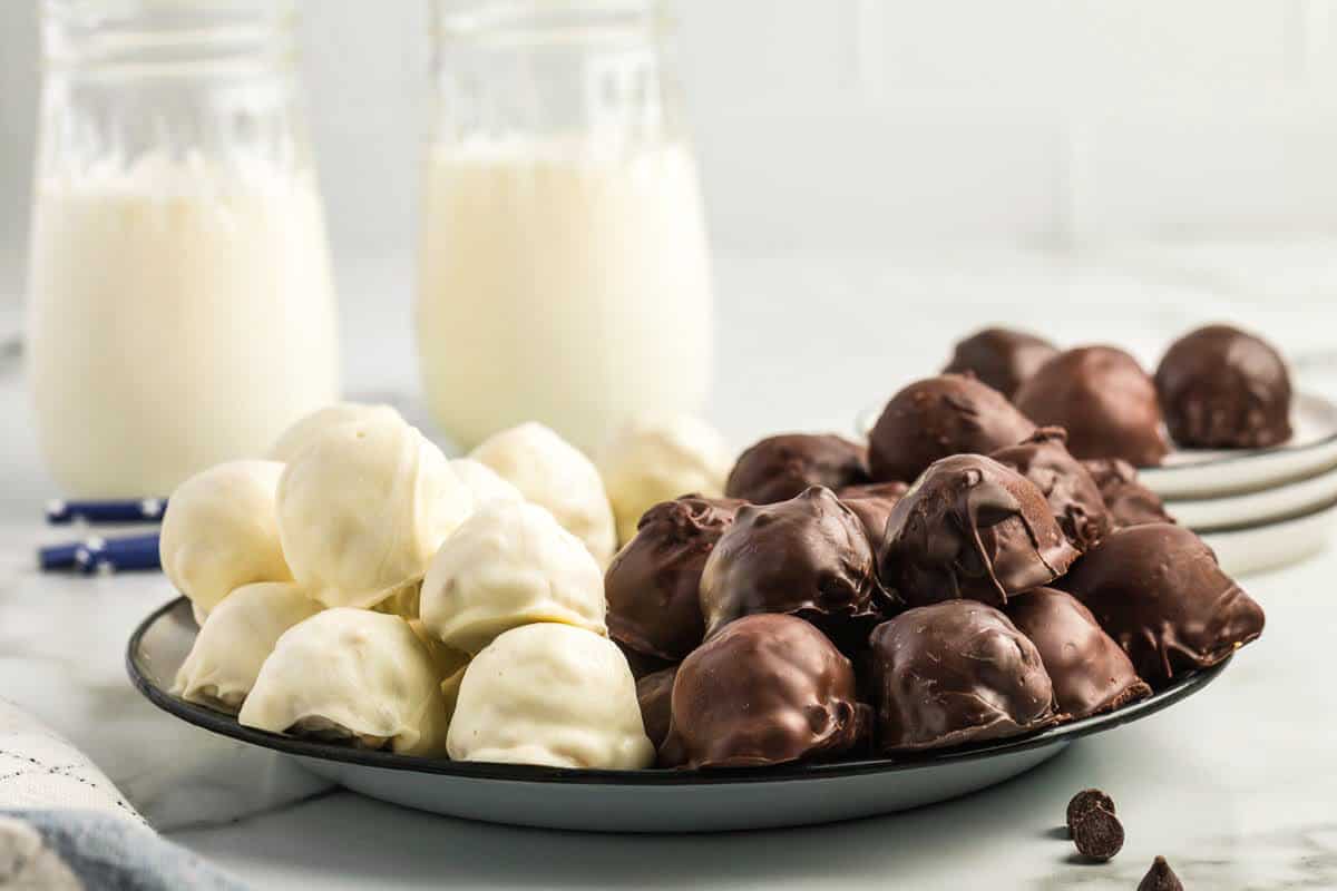 Peanut Butter Balls with Rice Krispies on plate with white and chocolate coating