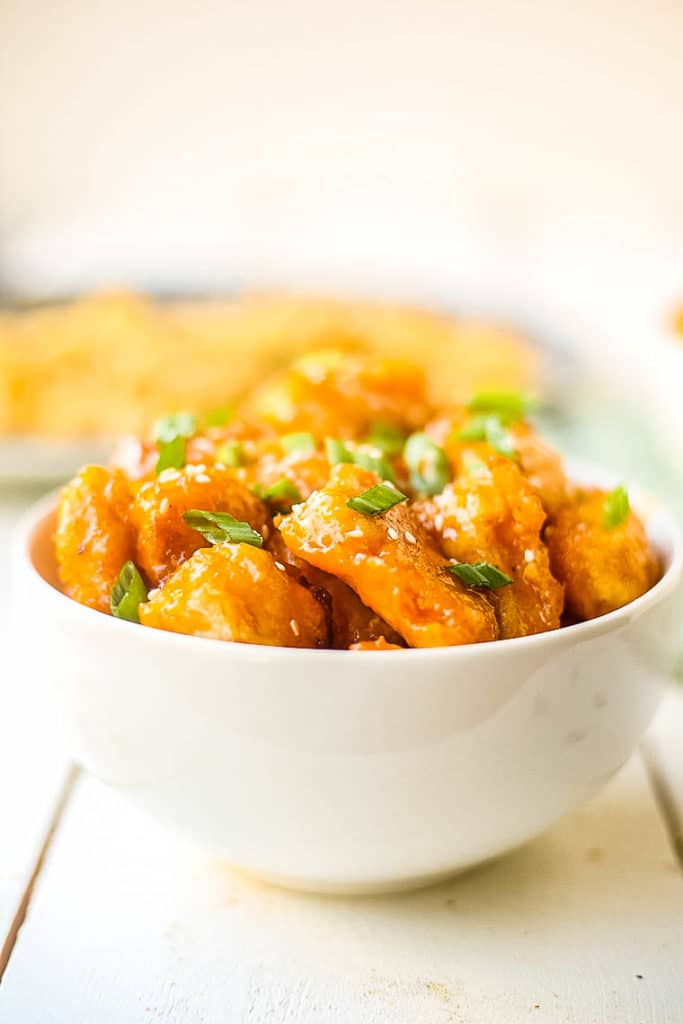 Homemade baked sweet and sour chicken on white background