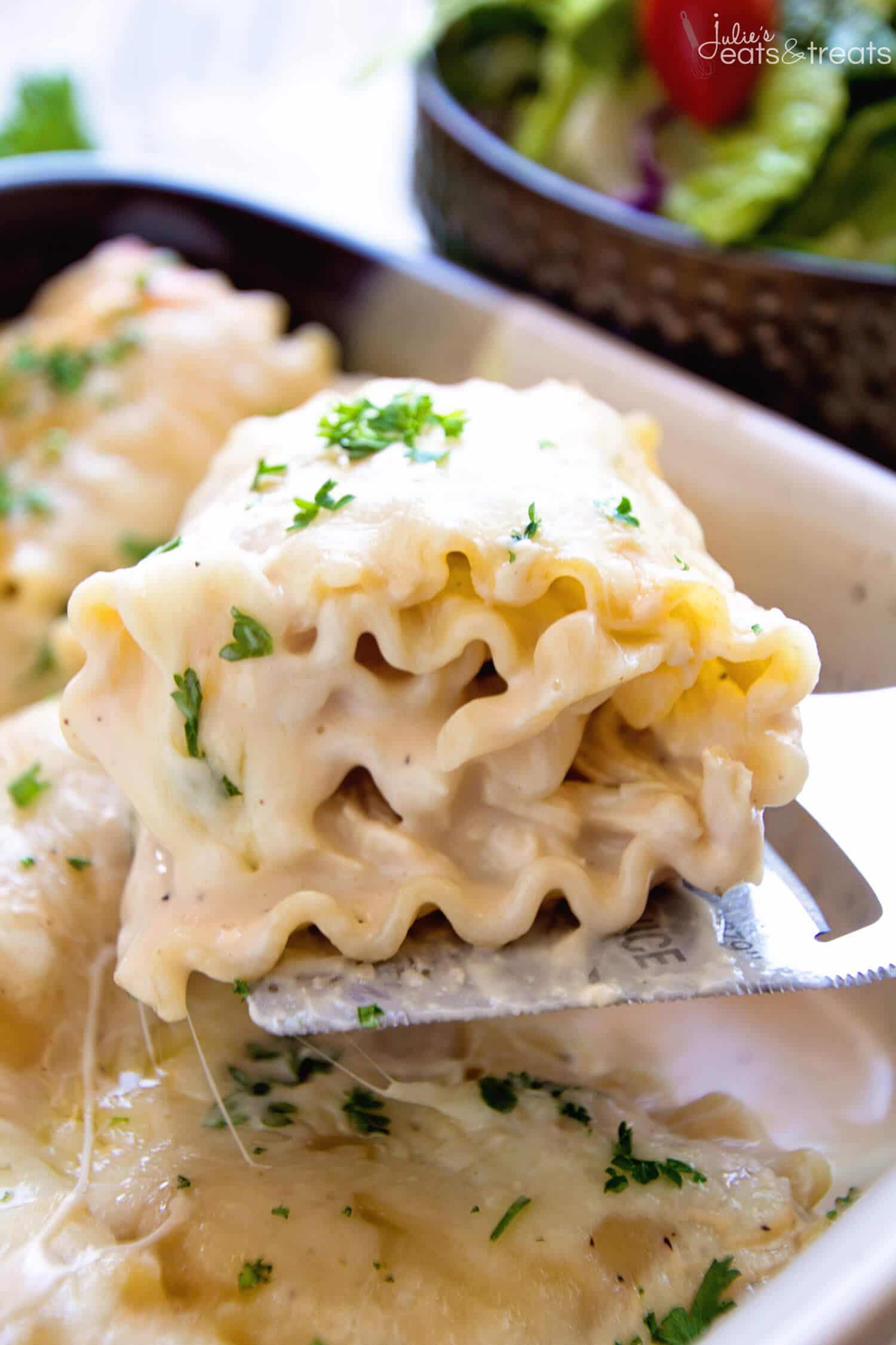 Metal Spatula with a lasagna roll up on it.