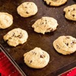 Twelve soft chocolate chip cookies on a baking sheet