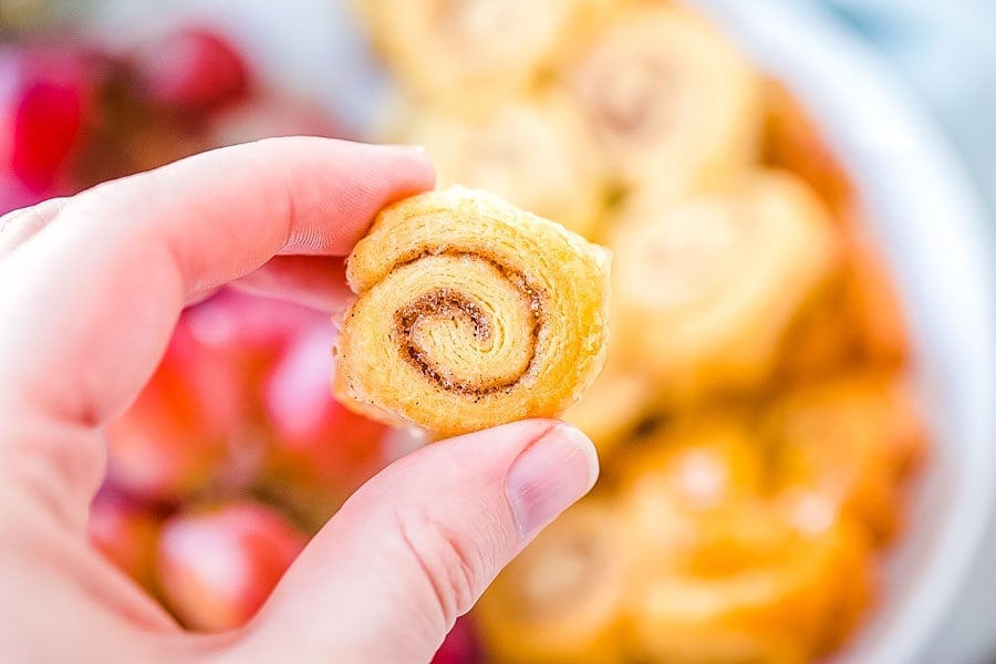 Hand holding mini caramel roll