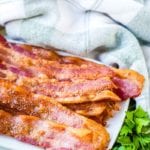 Oven baked bacon on a white plate