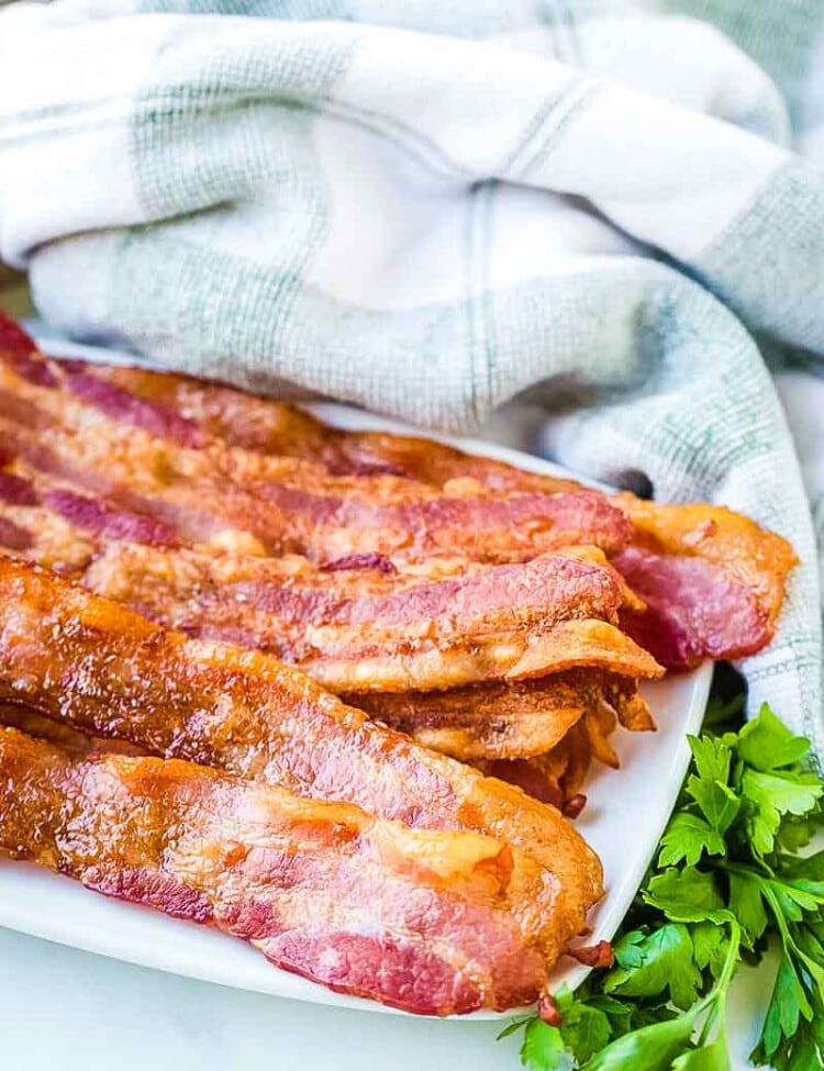 Oven baked bacon on a white plate