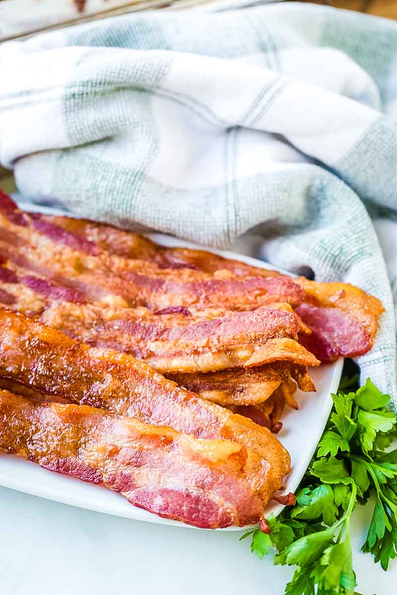 Oven baked bacon on a white plate