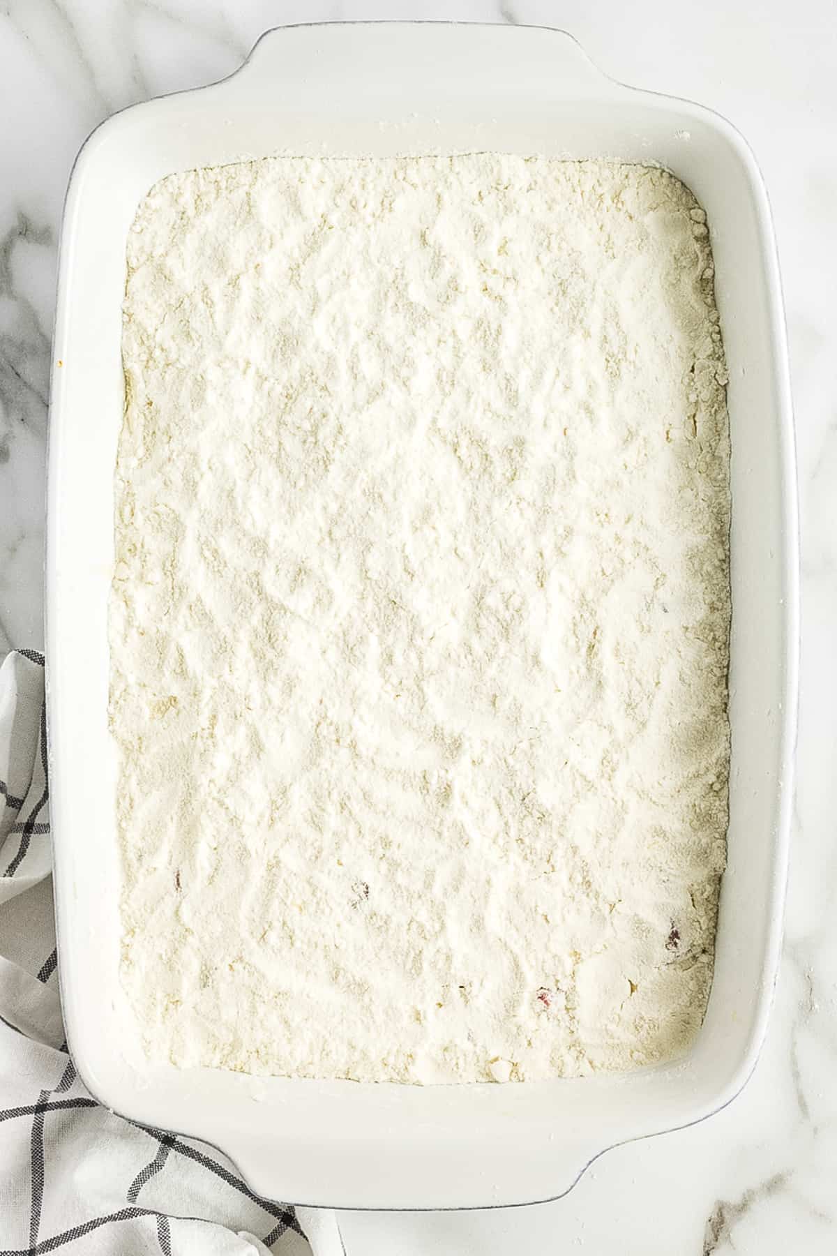 White baking dish with dry cake mix
