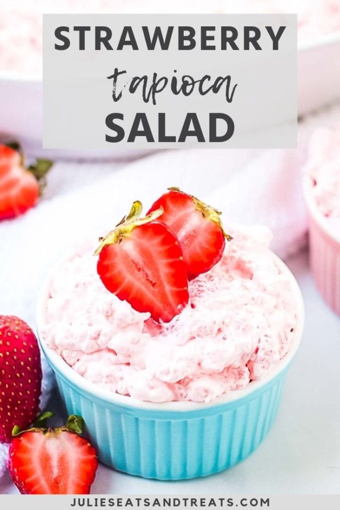 Strawberry tapioca salad topped with strawberries in a blue bowl