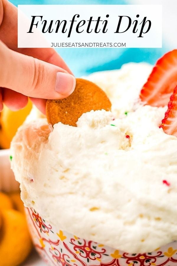 Hand dipping a cookie into a bowl of funfetti dip