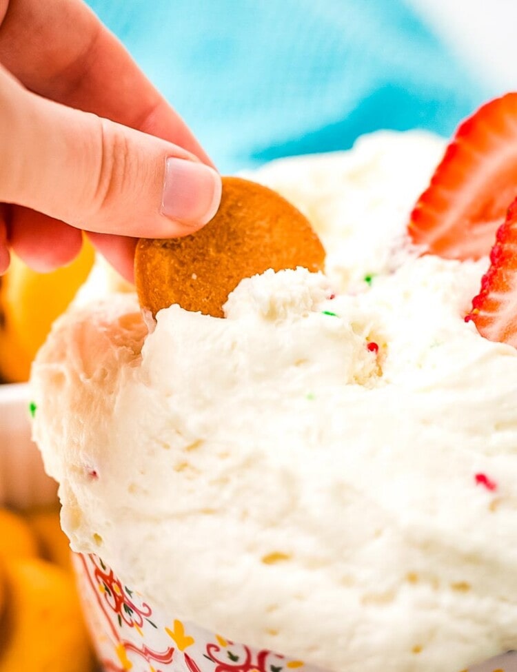 Cracker scooping Funfetti Dip from a bowl