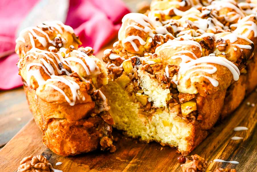 Apple Cinnamon Pull Apart Bread with a thick slice cut off the end of the loaf sitting adjacent from it.