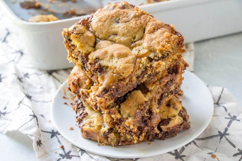 A stack of Knock You Naked Caramel Cookie Bars on a. white plate.