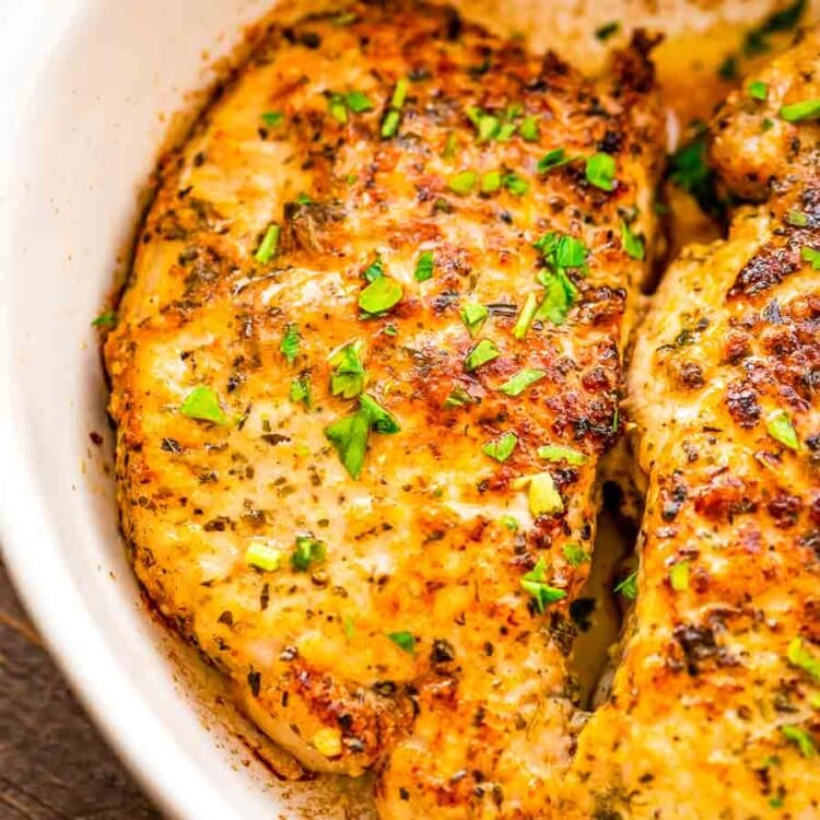 Parmesan Crusted Pork Chops prepared in a white baking dish