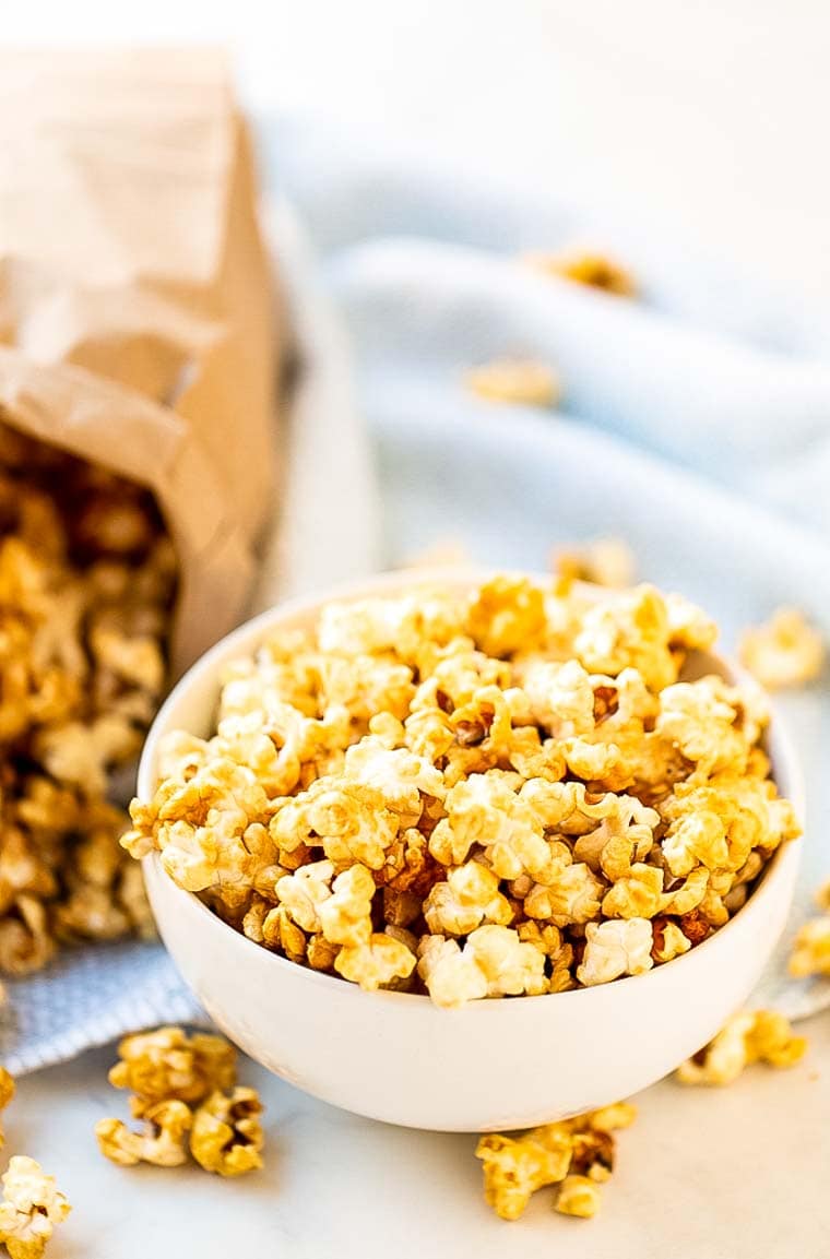 Caramel Corn in bowl with bag of it in background