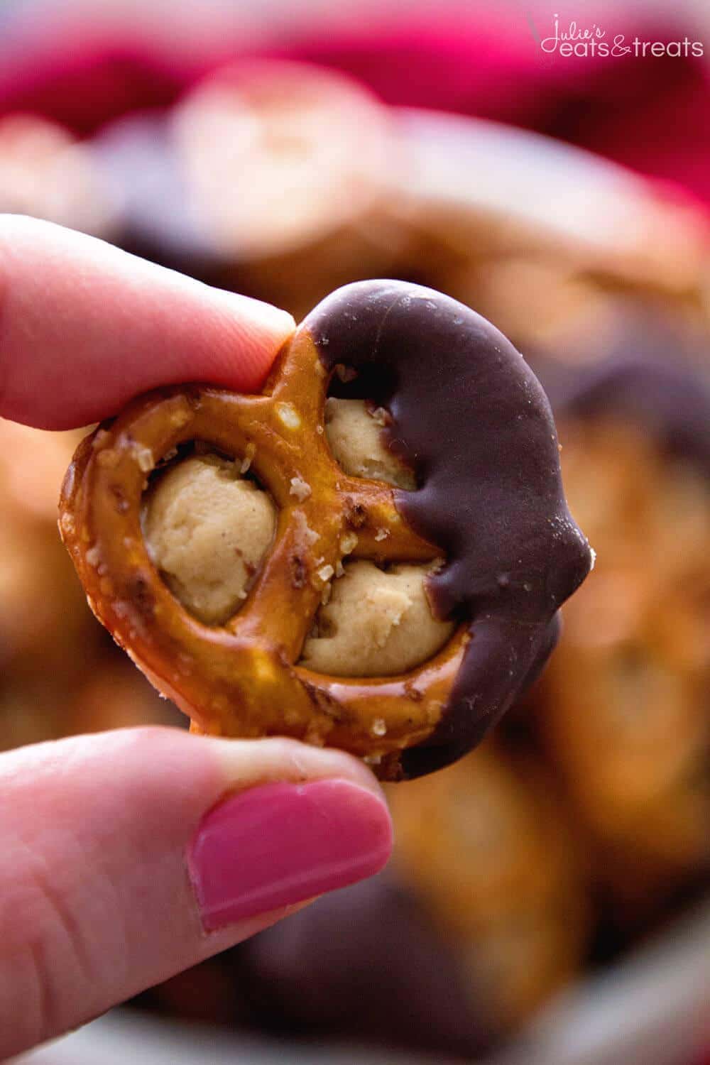 Chocolate Dipped Peanut Butter Pretzel being held between two fingers.