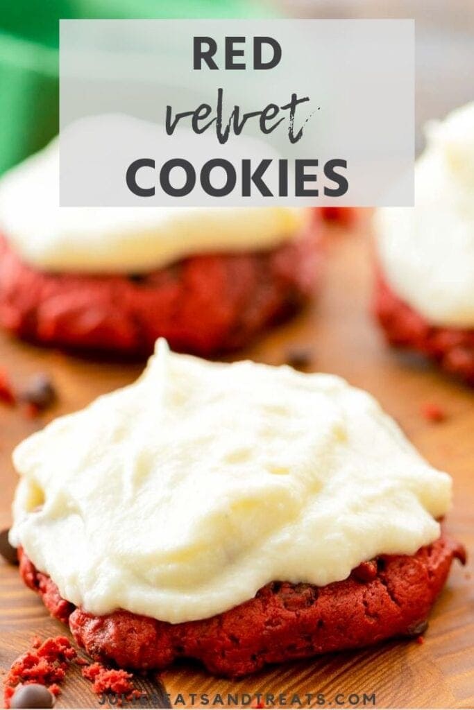Red velvet cookies with cream cheese frosting on a cutting board