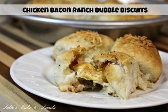 Three chicken bacon ranch bubble biscuits on a white plate with the front one ripped in half