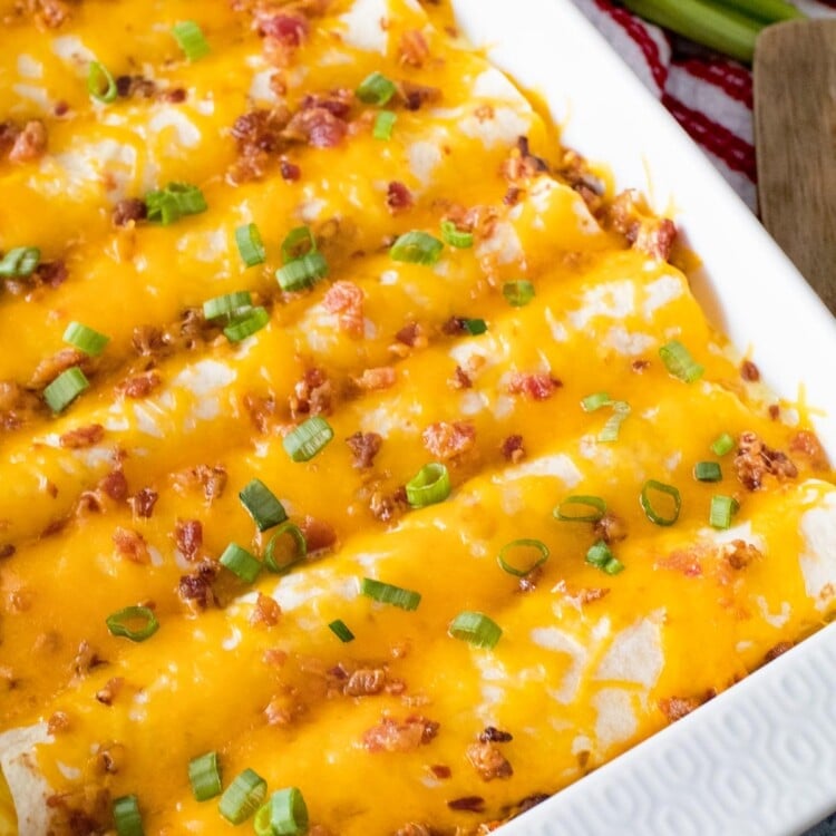 Overhead image of breakfast enchiladas in a white baking dish