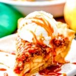 Slice of Apple Pie with crumb topping and ice cream on a plate