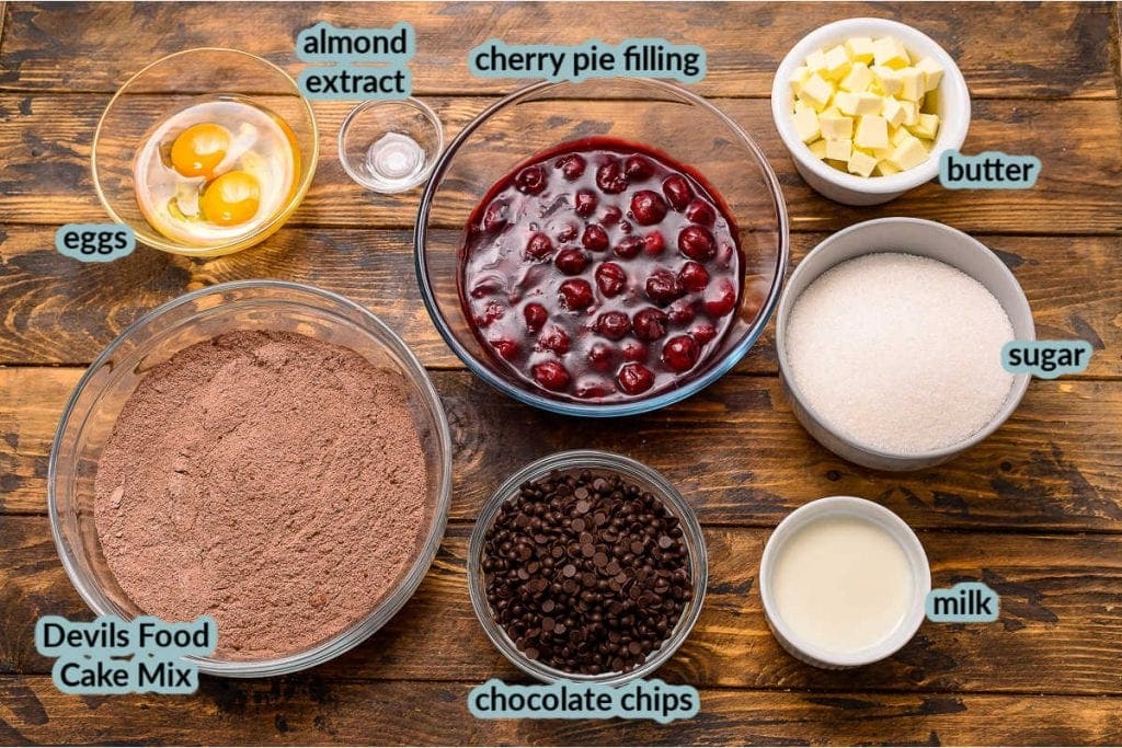 Overhead image of the ingredients for recipe cake mix eggs extract cherry pie filling and more