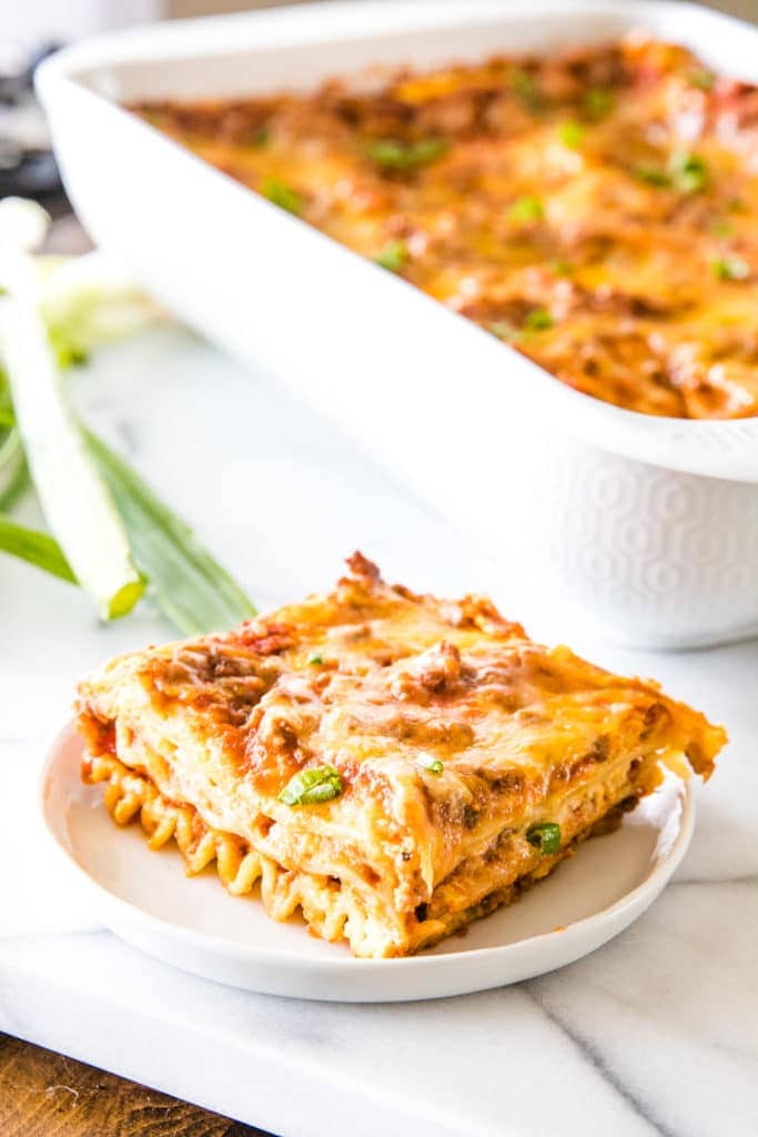 How to make Mexican Lasagna Recipe with a slice of Mexican Lasagna on white plate