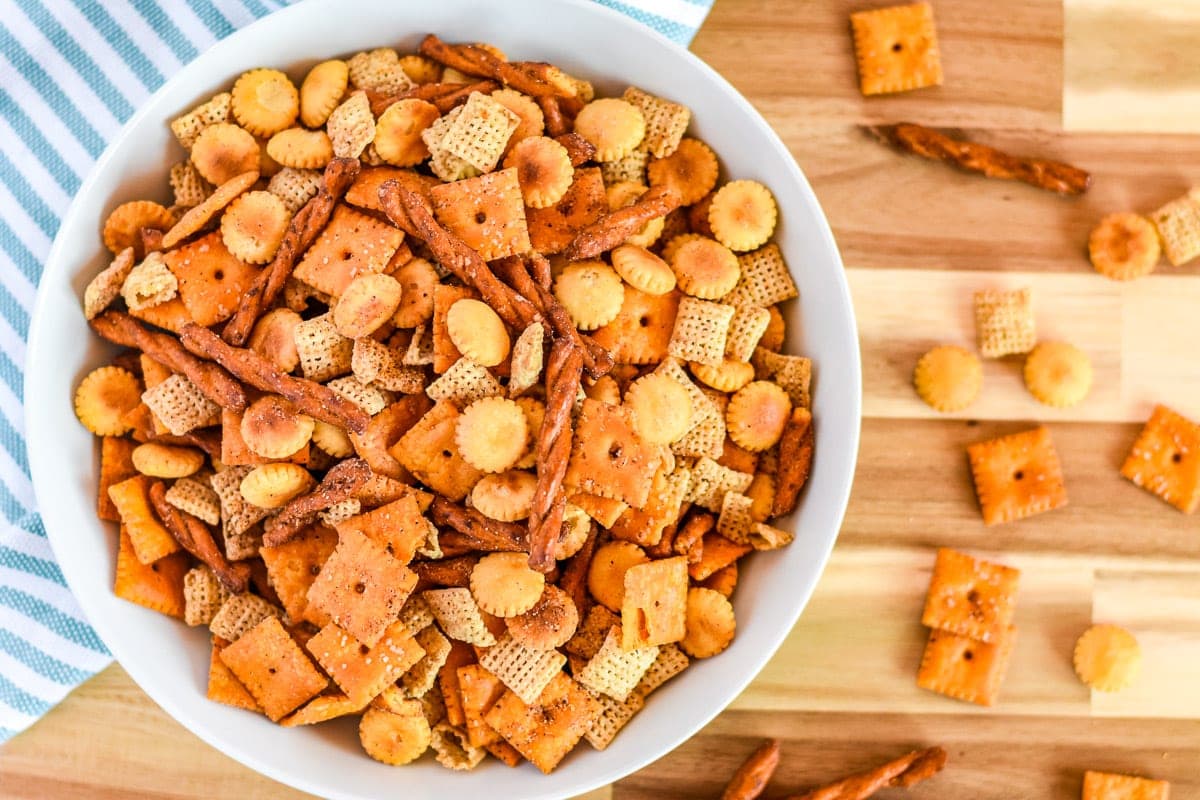 Wood cutting board with bowl of taco chex mix