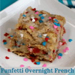A piece of funfetti overnight french toast on a white square plate with icing and sprinkles