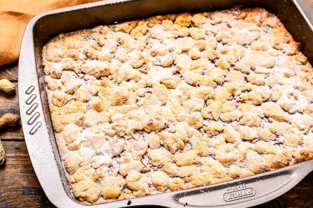 Pan with prepared Peanut Butter and Jelly Bars dusted with powdered sugar