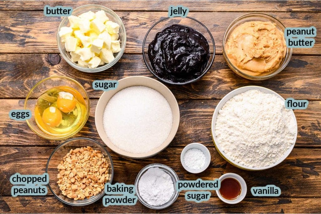 Ingredients to make bars including sugar flour butter peanuts jelly eggs vanilla and more