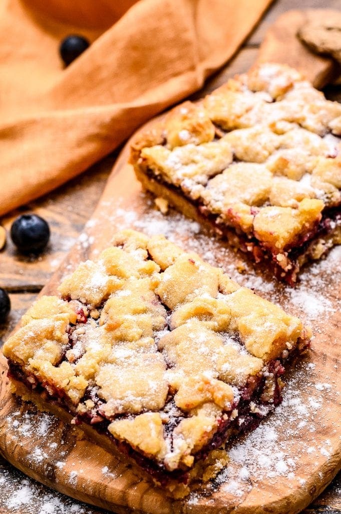 Prepared bars on small wooden cutting board dusted with powdered sugar