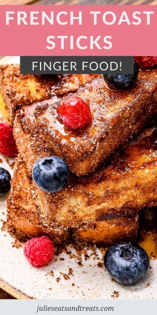 French Toast Sticks topped with syrup and berries on a plate