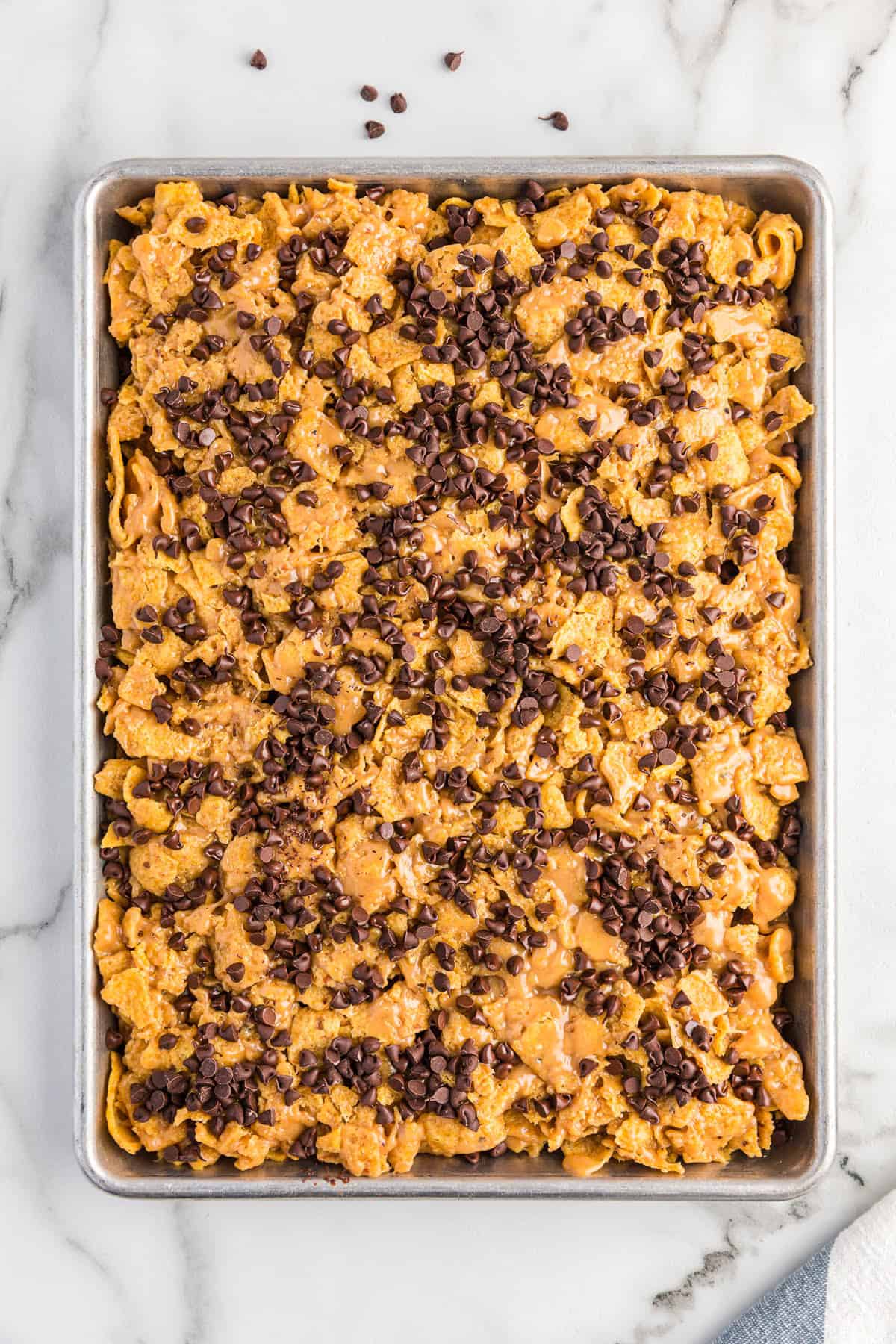 Second layer of frito bars in pan topped with chocolate chips