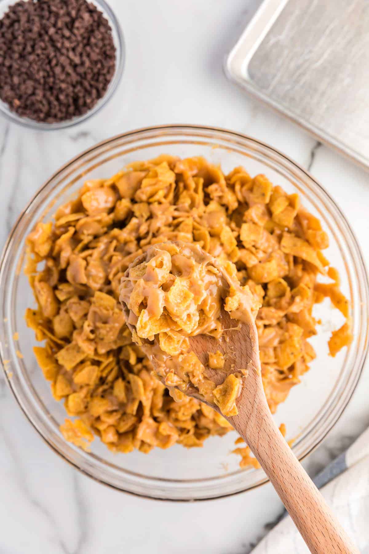 Mixing frito and peanut butter sauce in bowl