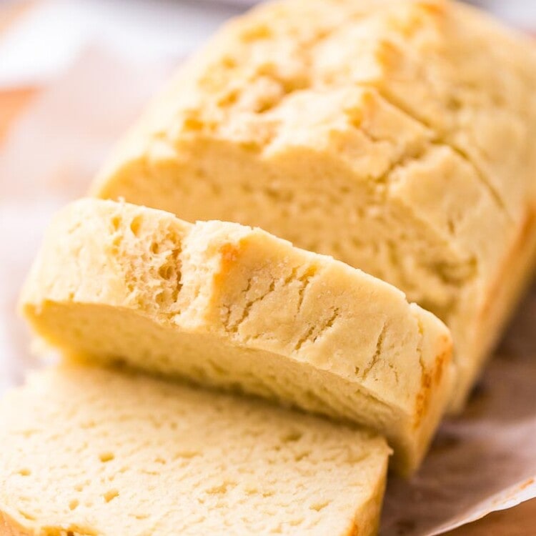 Beer Bread loaf sliced on a wood cutting board